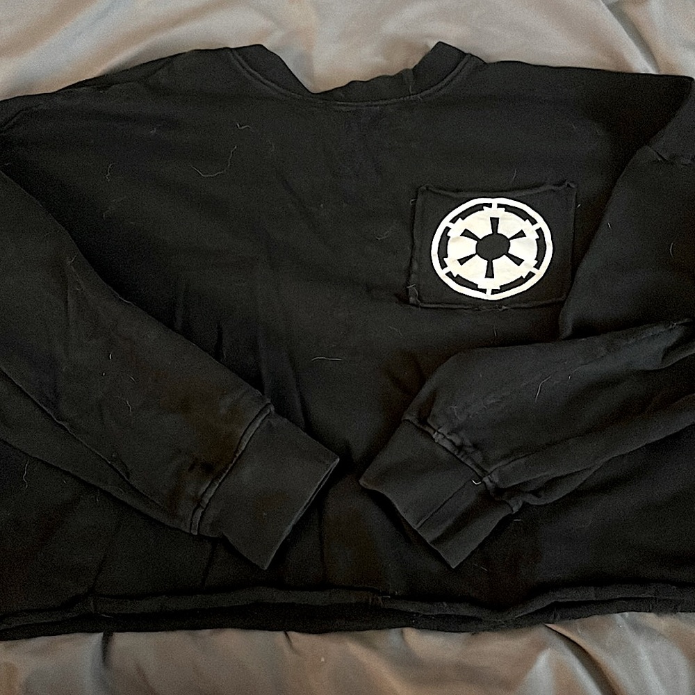 Star Wars crop long sleeve empire tee for women. Front pocket logo, “EMPIRE”
